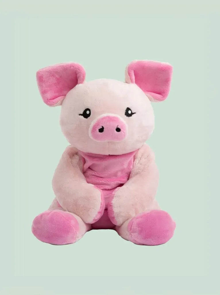 This image shows Harper the Pig Hugimal sitting down. Harper is a pink piggy stuffed animal with darker pink ears, snout, belly, and feet. Harper's hands are folded in Harper's lap. The background is a light mint green colr