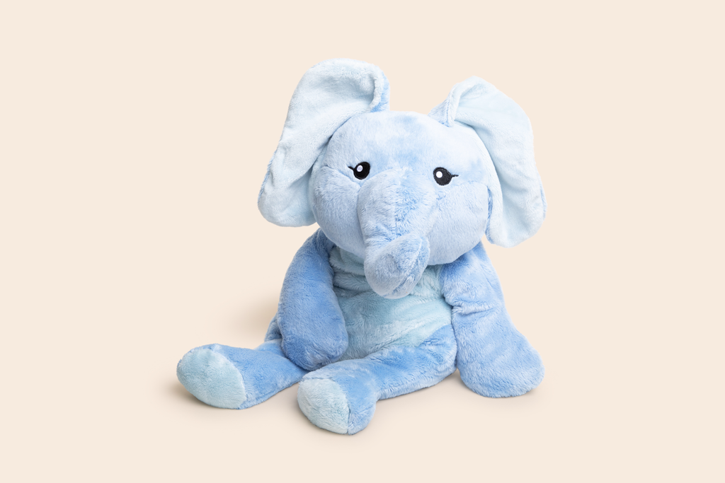 This photo shows Emory the Elephant Hugimal in a cute seated pose on a cream colored background