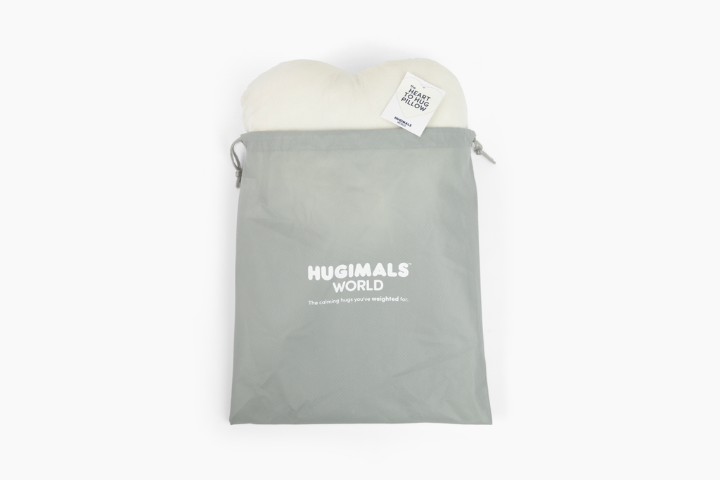 Image shows Ivory Heart to Hug Pillow emerging from gray gift bag