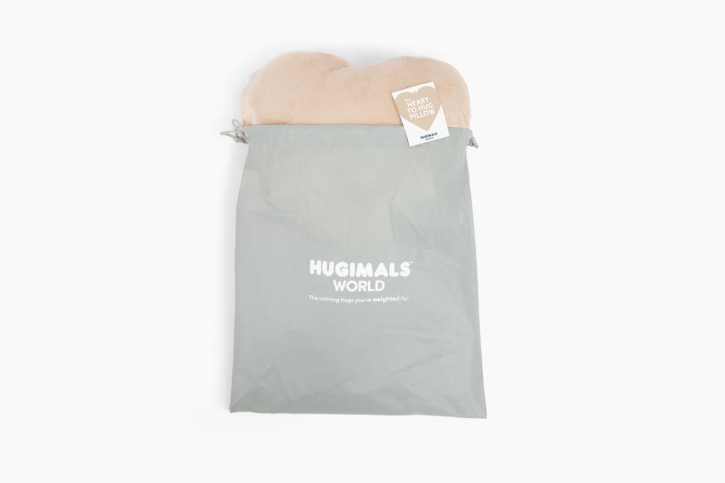 Latte Heart to Hug Pillow emerging from gray gift bag