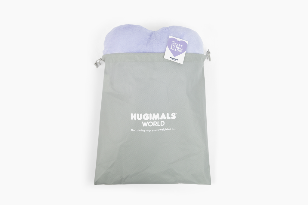 Lavender Heart to Hug Pillow emerging fom gray gift bag