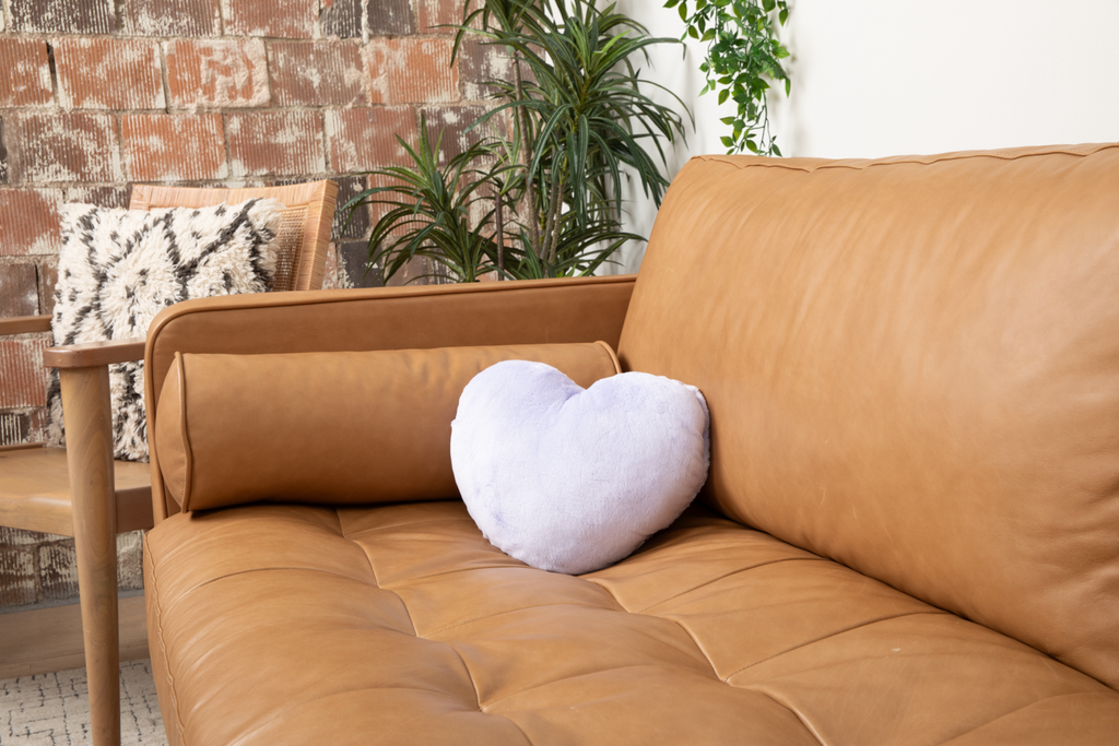 Image shows Loving Lavender Heart to Hug Pillow on tan couch