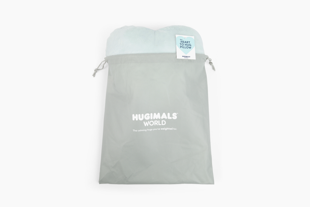 Mist Heart to Hug Pillow emerging from gray gift bag