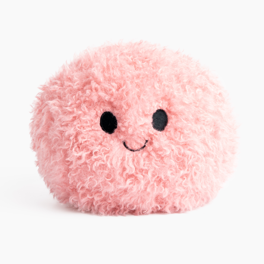 This image shows the Pink Hug Ball, with its "Happy" face facing forward, on a white background. The ball is made of plush with embroidered facial features and is cute and cuddly looking.