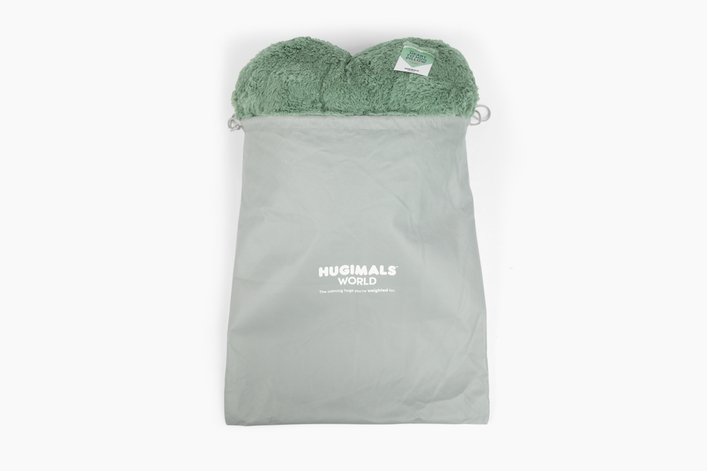 Sage Super Sized Heart to Hug Pillow emerging from gray gift bag